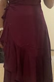 This was theoretically the perfect dress. Expectation: Bra friendly, flowy, satin look trim, beautiful colour, and quality. Reality: Terrible stitching, thread is loose, cheap fabric, and the design makes no sense as the frills are on both sides, so however you tie it, the frills are covered by the top layer and makes the person look frumpy and bumpy! I'm a size 6 with straight hips, and this dress has created width where there isn't any, rather than curves. Totally unflattering, should have trusted the other feedbacks. I can't return it. They charge $68. That's too much for no guarantee to get a refund of the balance. Strange material too like it's been coated in a greasy gloss. - Mina B.