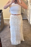 I technically should've ordered a medium, but I have a small frame with wide hips. It's also secretly elastic, so it fits perfect. It is so long, though I will see if I can have my lady tailor it to my height. It's too cute to return. - Christall A.