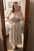 I bought this dress for my son's baptism. I am also breastfeeding, 7 months postpartum and am in between small & medium. The small is a tiny bit tight around the waist, but I think if I went up in size, it would be too big in the bust. It's a cute dress that can be worn during multiple stages of life! The background color isn't quite as pink in person as it seems online, but I still like it. I will probably pin the bust area for the church service to be a little bit more modest, but I'm excited about this dress and can't wait to wear it! - Stephanie M.