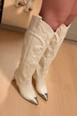 Cutest heeled cowboy boots. Purchased on sale, so I don't regret the novelty of it. I'm a true 6.5 in sneakers and boots, often a 6/6.5 in heels, and the size 6 in these boots fit me perfectly. The heel isn't too high, so it's perfectly comfortable for a night out. I have comparatively wide calves (but not so wide that I have to wear specifically "wide calf" shoes), and these fit fine! - Alison C.