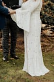 This dress hardly needs my review, since it got such a high rating already. But it is stunning and of wonderful quality in person. I ended up having the sleeves taken in a bit, since I wanted more of a flared sleeve than a bell sleeve. I got married 2+ years ago, and I STILL get compliments on this dress from people - Allison L.