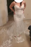 This dress is really pretty! I love the flower detail and that the flowers also have a bit of sparkle! The top is a bit loose and will need altering. A bustle will also need to be added. - Lucy E.