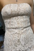 There's a corset built into just the top half above the waist, but it does not sit flat and looks like there's a fold in the dress. Even with trying to alter the dress, it's still sticking out. Not flattering at all, really disappointed - Nicolletta C.