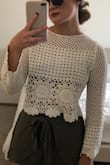 I ordered a small, and I love this top but had to return it because it just wasn't an incredibly comfortable fit. The sleeves are shorter in person as well. DEFINITELY get this, but size up!! - Dana H.