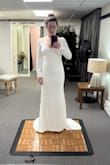 Bought this dress for my elopement, and I am so happy with it! These photos are from my alteration appointment, so you can see the pins in it. I am 140 lbs, 5'2", wider set on the bottom half (THICK BOOTY AND LEGS). I am wearing heels in this picture to have the dress altered to the right length. I originally bought a medium, but it was much too big on the top. The small fit is absolutely perfect except for the length, but that is always a given for me because I am short. It is labeled as a mermaid but did not really have that shape on my body, which I am really happy about because I am not a fan of the mermaid look. Small train, which I love. Tough to find the right underwear that doesn't show line imprints on my body because the dress is form fitting at my hips, so I bought Spanx that go just below the bust, and they worked great. No bras, just cakes nipple covers. Cannot say enough great things about this dress, and so happy with my purchase! - Emmy B.