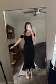 It is stretchy and I wanted a tighter fit so I did get a size down. Luckily the black is very forgiving. Will be wearing again to other weddings! - Madison F.