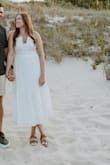 I bought this dress for my engagement pictures, and it was perfect for beach pictures! First true to size with a little stretch. Some of the reviews say it is see through, but I wore nude undergarments and had no issues - Lindsay S.
