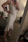 I bought this for my bachelorette party, and I love the cut/fit! It's super stretchy and easy to move in, plus the halter gives a nice support to the bust area. It's also not too sheer for a white dress. - Megan K.