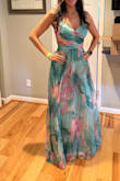 It's flowy, perfect length on me with reasonable heels, and I'm average height. It's got good weight to it. The print and style are lovely. The cutouts hit exactly where I want them to, although I wish the back didn't have an additional cutout- just the sides seem to be flattering enough. I took off one star because I think it's priced too high and the overlay skirt is a fluffy chiffon that can add girth and wimpy spaghetti straps. The picture is me in an xs, but I returned because it was too tight. Waiting for it to go on sale so I can grab the small. Overall spectacular and worth owning. - Marline K.