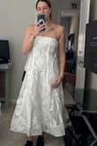 It felt a little more stiff than I expected it to. I guess there is boning in it, but the picture makes it look more flowly. Just didn't sit right on my body - Ibby B.