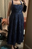 It's a really beautiful dress, and the layering is nice. The material looks more expensive than it is. Big chest friendly! The lace-up backing is great for adjustability, although it's made out of the same material as the top layer, so it slides less easily/evenly. Not an issue, just noticed. The biggest problem is that the waist is too tight. The elastic on the back really doesn't do anything to help. It's not so tight that it doesn't fit or hurts, but not sure I want to wear it for hours at a wedding, especially when I'm sitting down. It's definitely designed for an hourglass figure or maybe athletic build. I do really love it so I might see if I can do something to tailor it and add a little bit of space. Otherwise, I may have to return it. Unfortunately, there is no sizing up since I already got an XL. Otherwise, I could tighten the laces and sit comfortably. - Mollie R.