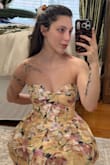 This dress is absolutely stunning and well-made. It does run slightly small in the bust. I was able to clip it shut, but only zip about 3/4 of the way. I'll be exchanging for the next size up. I'm typically an xs, so hopefully the small will work perfectly. In these photos, I am holding the zipper closed to see how cinched it would make my waist if zipped properly. Overall, beautiful dress! - Nikki D.