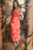 The color is a bit more orange than pink, but it is super soft and comfortable to wear. It's definitely a form-fitting dress, and some of the material on the butt bunches up a bit, but it's not too annoying to just smooth out. Stops above the ankles and is perfect for a spring/summer wedding! - Morgan B.