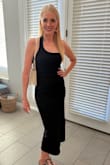 This dress fits very well. I have a semi-athletic build, am not very busty, and a medium fit perfectly. The fabric has give and is stretchy. It has a pretty high slit, but nothing that was too much or cheapened the look at all. Really great dress for girls' night, cocktails, or an upscale function. - Michelle S.