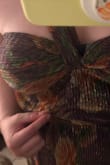 The breast cup area is very, very small compared to a normal Lulus size. The over-the-shoulder concept is fun, but it pulls in a way that shows the lining of the dress, which is in a different color,  badly designed. There was also a ton of loose material in the torso that made it look like the dress was too tight and fat was spilling over, even though it was loose. And the material itself was very uncomfortable. This would be horrible for a summer wedding. - Melissa T.