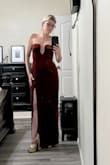 Soft material. Tight around the bust area, beautiful gold rim... very unique dress. Not red, like a deeper dark cooper - Yery Q.
