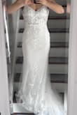 It was beautiful and had a great train and lace detailing, but the bust was stiff, and I didn't fill it out well enough for it to be comfortable. Felt very high quality for the price! - Erin H.