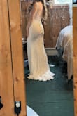 I ordered this as an option for my wedding dress and fell in LOVE with the silhouette. The straps were too long on my shoulders, but that is true always for me because I'm so short. 

The neckline is kinda weird, and the fabric is a good bit see through below the bodice. 

The fake buttons also look very cheap 

For 180, a total steal - Bethany K.