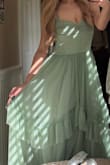 The dressy was really flowy. If you're petite or a bit shorter, you might have to get it hemmed or wear taller heels. It was a little hot in the sun, as there isn't too much airflow under, but it still worked for us! - Tiffany H.