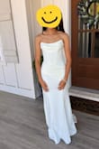 This dress was stunning. I purchased it from Prom, and I did not have to get it altered at all. I wore 3 inch heels, and it was the perfect length. I wear size 0/2 and ordered XS. The fabric has a little stretch to it, and with the corset closure in the back, it makes it really easy to get the perfect fit by adjusting the ties in the back. - Janell N.