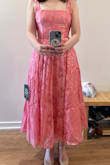 This dress is so much fun! I love the color (quite a bright pink!) and the flower pattern. While the adjustable back is wonderful, I will say that the top part of the dress is a bit stiffer than anticipated. There's also tulle under the skirt part of the dress, which definitely feels princess-y. My best friend from high school is getting married and hoped I would wear pink as her maid-of-honor. I think this fits the bill perfectly. - Elizabeth L.