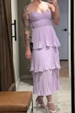 I really wanted to love this dress! It looks so perfect on the model. I ordered a medium (photo for reference) based on the size guide, but unfortunately, the bust fit very oddly. It was too big on the sides (under my armpit), and what I thought would be boning under the breasts was not enough to provide any support. It was just a nicely placed detail to look like a corset, but it doesn't actually lift anything up. And I have relatively small boobs. Plus, the midsection has this extra fabric for detail, but unfortunately, it just looks baggy instead of flattering. I then ordered a small thinking it would resolve the issue, and while the bust area fit better, it still had that extra fabric in the midsection that gave me a weird pouch where I didn't need one. The quality was not up to Lulu's usual standards. I'm hoping to find another one like it, because I do love the color (lavender) and the tiered style is really elegant. - Devin H.