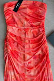 I wish the color were more like the photo on the site. It's way more orange in person, but I'm still planning on wearing it to my friend's spring wedding. The material is very stretchy and comfy. - Alyssa A.