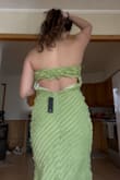 The material is stretchy and thick. The back is loose and fits weird. I had to get mine tailored to fit my back. - Paige P.