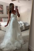 Purchased this dress for my upcoming wedding, and it is absolutely stunning. I am approximately 135 pounds and wear a size small. Being a short girl at 5'3", the length is definitely way too long. I do find the dress very bottom heavy, and it frequently shifts down. But having got the dress at a steal of $75, I can certainly afford to have it altered to fit perfectly. I'm going to have it shortened, install a waist stay/seatbelt to prevent falling down, and a bustle in the back for the reception. Overall, the dress is stunning, and I hope that the alterations make it absolutely perfect for my wedding day. - Candi M.