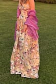 The dress is beautiful. It's perfect for a formal garden wedding. I got lots of compliments on it. It had some fraying and loose threads after 2 wears, but nothing too noticeable. The length of the dress was fine: I'm 5'4". I wore 4-inch heels, and when standing straight, the dress hem just grazed the floor, but when walking and dancing sometimes I'd end up stepping on it. The only downside of this dress was that the neckline and the built-in cups showed too much cleavage. I was able to wear a strapless bra with the dress, which minimized the cleavage line, but because the top was slightly loose on me (a problem I often have because I wear size 2 in tops but size 6 in pants), sometimes the top edge of the bra would show, especially when moving and dancing a lot.
By the way, I would recommend pairing with pink or purple accessories because it turned out to be very difficult to find matching yellow accessories (and if you're blond, the yellow of this dress can wash you out). - Nadia A.