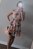 I read reviews before ordering this dress, so I ordered an XS when I normally would've ordered a S, and the XS fit perfectly. The criss cross straps across the back, being adjustable, help you sculpt it to the exact tightness you prefer, which is nice. Definitely a cute dress and fit is great, just too girly and young looking for my taste, which is what I was worried about when I ordered it, but figured I would take a chance on it. Will be returning. - Marissa K.