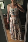 This is absolutely gorgeous. The waist is elastic and the back ties, so I originally ordered a medium and returned for a size small, which fits perfectly. Definitely keep the ability to expand in mind, as it doesn't fit correctly if it's too big. Like other reviews have said the skirt is long and you'd likely have to hem it to wear it with low heels or flats. But it's so beautiful it's definitely worth it. Can't wait to wear this on vacation and once the sun comes out! - Ashley M.