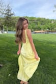 I needed a yellow dress for a wedding. This dress is a little more lemon yellow than butter, but it is a nice shade and has a striped sheen to it. It's fully lined, and I wore stickers under it. It fit me perfectly, no gapping and no alterations needed. - Zoe G.