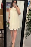 I was worried ordering this in a medium, but it turned out perfect based on their suggested size for me. I love the dress. It's very comfortable and flowy. It's easy to put on, and it's not too short! The color is not as white as the photo. It's definitely a cream color, giving off sort of yellow tones. It's still beautiful, just not white. I was looking for white, but I'm still very happy with this dress. I rated 4 only because of the color being misleading. - Nina P.