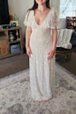 I really loved this dress online and wanted to love it in person, but it was not THE dress for my wedding. The beading was beautiful, but there was some already falling off just with the try on. The quality did not meet the price in my opinion. The deep v front and back was my favorite and was very flattering on me. The sleeves were gorgeous. The dress was surprisingly heavy due to the weight of the beads also. Overall, the dress was very nice, and I would recommend it to someone who wants a more whimsical vibe. - Deidra W.
