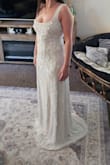 This dress was like a long, plain white tank top with beads. The straps were way too long, and some beading was falling off straight out of the bag. There was a black smudge of who knows what on the inside when I went to try it on. This dress is wayyyyy overpriced in my opinion. I would not recommend this dress, to be honest. - Deidra W.