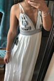 I'm a petite girl that usually orders a small/medium. The model is wearing a small but when it came the break area was very baggy and the wait is extremely stretchy so it could fit many waist sizes. I ended up ordering the XSMALL (shown in photo) and the length fit perfect with a pair of heels, only other thing is the straps are difficult to tie/figuring out how to tie it. - Callie B.