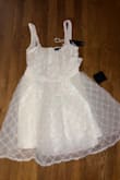 I thought this dress for my graduation, and the dress itself is ok. It did fit more frilly and looked like something my 3yr old niece would be dressed in. However, I would have liked it if it actually fit me. I ordered a small and fitted perfectly in a small according to the size guide. The whole bodice was too loose, and the straps were very long, considering I'm pretty tall too. The dress was a decent length, but the zipper is a little cheap and hard to open and close. If you have a smaller bust, this dress will not fit in your recommended size. I would heavily suggest subtracting 2/3 inches from your waist and bust measurements to get an accurate fit and expect the neckline to be very low and need an adaptive bra for it to not show. It's not extremely see through for a white dress, but I would still suggest nude undergarments. If I am an xs in this dress, and you are any smaller than me, they do not carry your size. - Cassidy P.