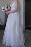 So I really wanted to love this dress. For the price, it felt very romantic and bridal, but it gives a really unflattering silhouette.
I am slender - 5'8" and 130 lbs. But this dress made my ribcage look super wide, and it was a really strange length in the bodice. If the skirt started to poof out a little lower, it may have worked. But my typically long upper body felt really stumpy, and despite my slimmer figure, it made me look like I was pregnant. It gave me the strangest silhouette, and even with alterations, it just didn't work. I spent $300 on alterations, and it didn't look any better. My seamstress also said that it was difficult to alter because of the cheap fabric and the fact that it was built in panels.
So, unless you're willing to spend more on alterations than the dress itself, I would think twice. It runs really large and has a really low neckline, which didn't work for me as a woman with a smaller chest.
And the zipper issue, as many others have noted. - Kelly J.