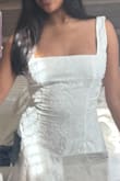 This dress is super cute. I did buy it for graduation, but I feel as though it is not as pure white as the photo. It's tight on me, and if I sit, it constricts, but a size bigger would be too loose. The straps are also a bit too long, but with a bit of stitching it down it will be perfect. The material is quite sturdy as well. - Lizeth A.