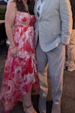 I absolutely love this dress. It fits perfectly. I'm on the shorter side, so the higher cut in the front was perfect. I wore high strappy wedges too. The straps are adjustable to help with chest coverage. I'm very pleased with this dress. I wore it to a welcome party for a beach wedding. - Jenna K.