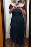 The material and color is beautiful. The dress is not cheap looking. I bought it for a July 4th wedding.  It definitely runs small. It has no give to the material. I bought a M and L. Tried on the L. Tightest part is around the zipper at your waist. I just ordered an XL for comparison. Whichever way it goes, I am definitely keeping one! - Randi H.