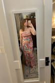 I think in general this dress runs a little large. I'm between a medium and a large, and I was expecting the medium to be tight, but it fit perfectly! I was going to wear this to a gala, but was told it was too wild of a print, so I don't have anywhere to wear this, but I loved it so much I decided to keep it.  Hopefully I'll get invited to a summer wedding sometime. - Kathleen O.