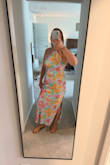 I bought this dress for a wedding rehearsal dinner in Florida and loved it. It was tighter but not super form fitting. Still have room to breathe. The material is a silk and is very easy to steam to get wrinkles out when traveling. The slight in the side makes it very easy to get around in. The back is open, which makes a bra harder, but I used fashion tape on the sides, and it held all night! - Paige H.