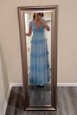 The dress is stunning and feels well-made for the price. I love the color. The plunge goes pretty deep, but I don't think it looks too revealing though. I plan to secure the dress in place with fashion tape for the event because it doesn't feel tremendously secure for dancing. It almost grazes ground when I am barefoot, so be advised if you are much shorter or much taller than me 5'10. - Erin H.