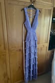 The colour is beautiful and looks like a nice silvery lavender in the light. The back is so easy to tie up and easy to get into the dress. Whilst the slot is quite high, it's not revealing but if you're going to be dancing and moving around a lot, I would recommend you choose suitably what you want to wear under. I have a flatter chest so the built in cups worked perfectly and didn't feel like I needed any more support and the back can be easily adjust. The cutouts sit at just the right height and length turned out perfect as I'm taller so overall would highly recommend as I've had so many compliments! - Hope T.