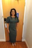 The dress is a beautiful dark green color. It's much longer than pictured, but doesn't require heels. It's really thick material, so great for cooler weather. It hugs you all over, so it appears more formal than it looks on the hanger. I loved that it was so comfortable to wear. - Josie T.