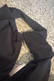 Quality thick material, and very form fitting, but not in a bad way. It was tight over my hips and belly (I also had a baby 6 weeks ago so I'm a little wider through the stomach and hips than I usually am. Usually I'm a medium so I knew I'd have to size up). The fabric has some stretch so it wasn't hard to get on or off. Unfortunately, the zipper broke instantly when I tried it on. It went up no problem, but came apart in the middle and now won't budge from the top. Bit bummer. - Rhiannon S.