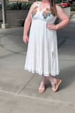 I bought this to wear for my small court wedding. I love it! I received many compliments. It is slightly see through on the bottom half- so plan under garments accordingly. It was slightly tight in the rib cage area, but I got it let out easily by a seamstress. I did get it hemmed and added a mesh fabric to the back opening. I'd highly recommend this dress- so easy to dress up or down. - Carly R.