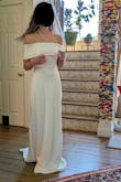This is a beautiful dress, and the top is stretchy/lined with silicone, which helps it stay up easily, however it is impossible to lift your arms up from your side due to the thick band. - Lucy U.